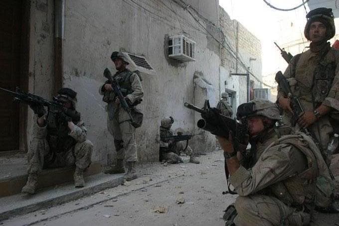 Marines holding a corner during a street patrol in Iraq
